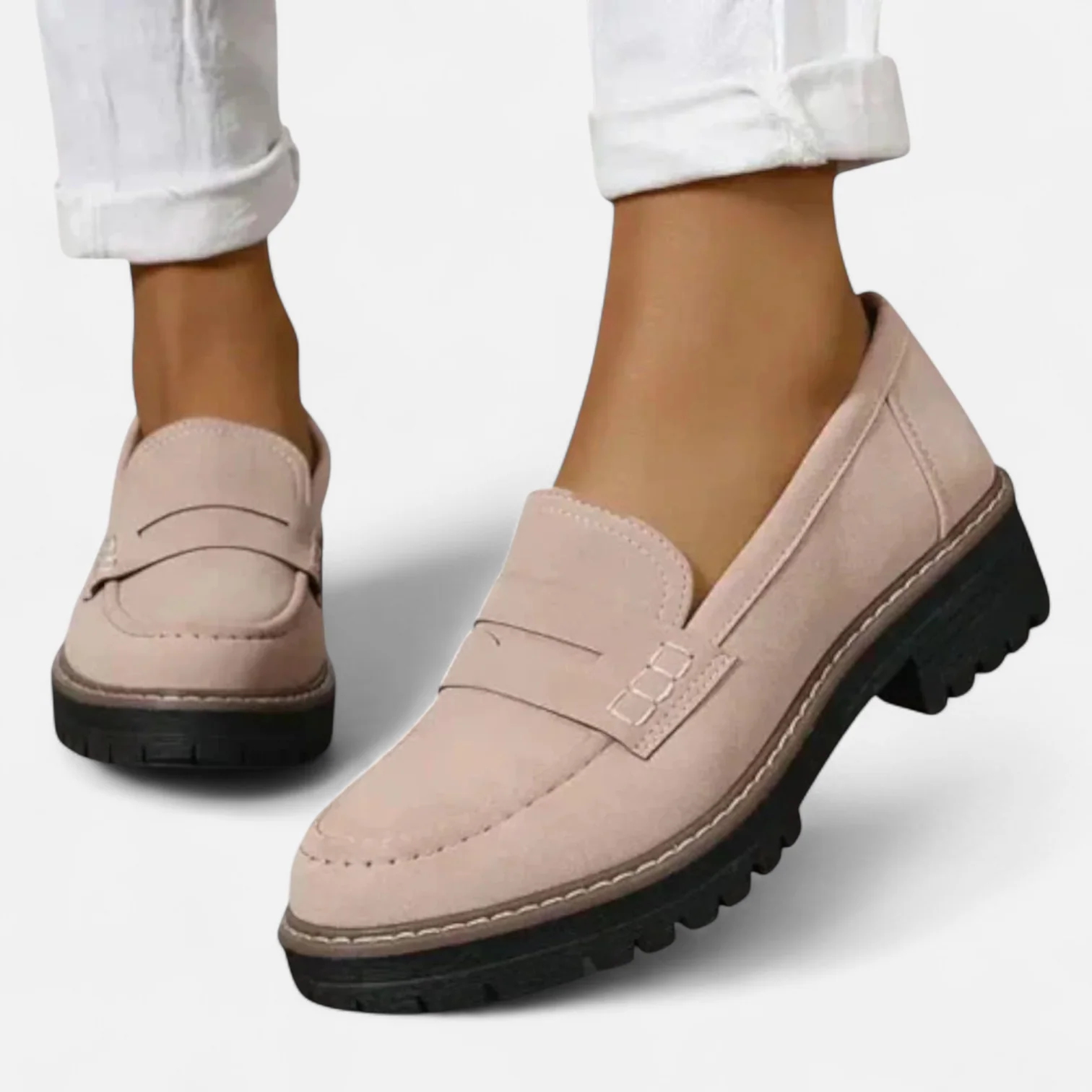 Woman wearing black loafers while standing, full leg view
