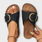 Model wearing cork buckle sandals, standing pose