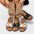Model wearing cork sandals, seated side angle