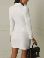 Black blazer dress with cinched waist detail, seated position