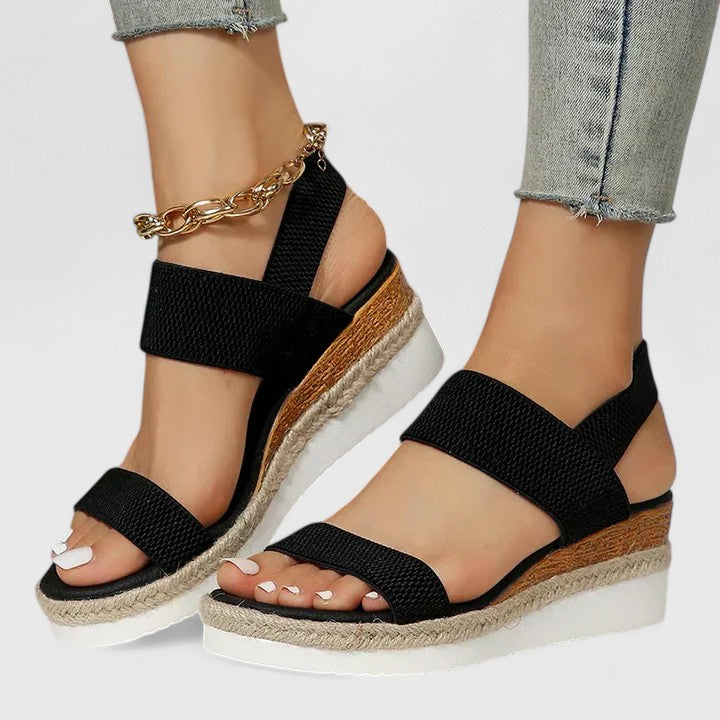 Black espadrille platform sandals displayed on neutral background