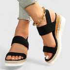 Woman wearing black platform sandals, side profile shot