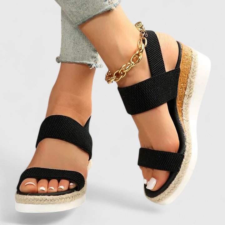 Woman wearing black platform sandals, side profile shot