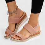 Back view of woman wearing black platform sandals