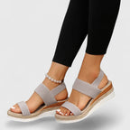 Woman walking in black platform sandals, outdoor setting