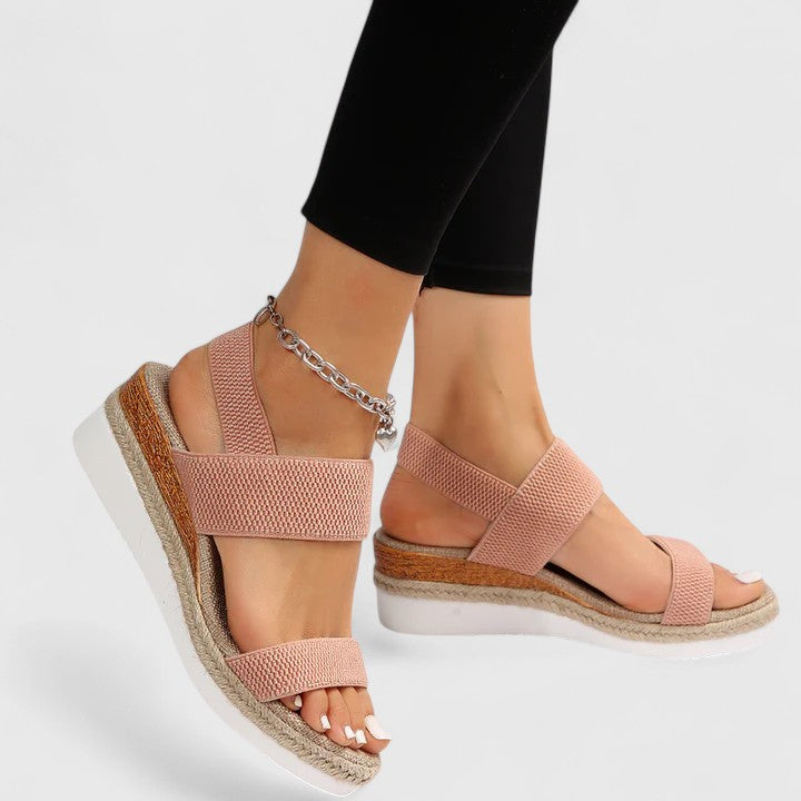 Top-down view of black platform sandals on foot