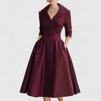 Side profile of woman in leather midi dress showing wrap bodice and fitted waist