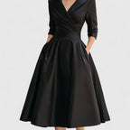 Angled side view of leather midi dress hem and skirt flow