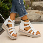 Woman wearing gladiator sandals, casual seated pose