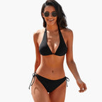 Black halter triangle bikini set laid flat on white background