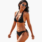Woman wearing black halter bikini, front-facing pose
