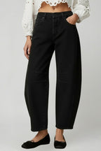 Model wearing black wide leg jeans, standing pose full length