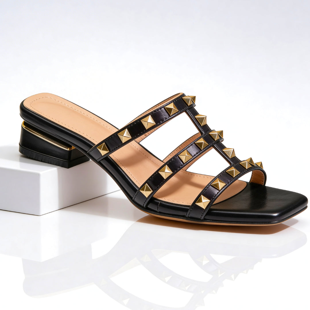 Black leather studded mule sandal with gold pyramid studs and block heel, front view