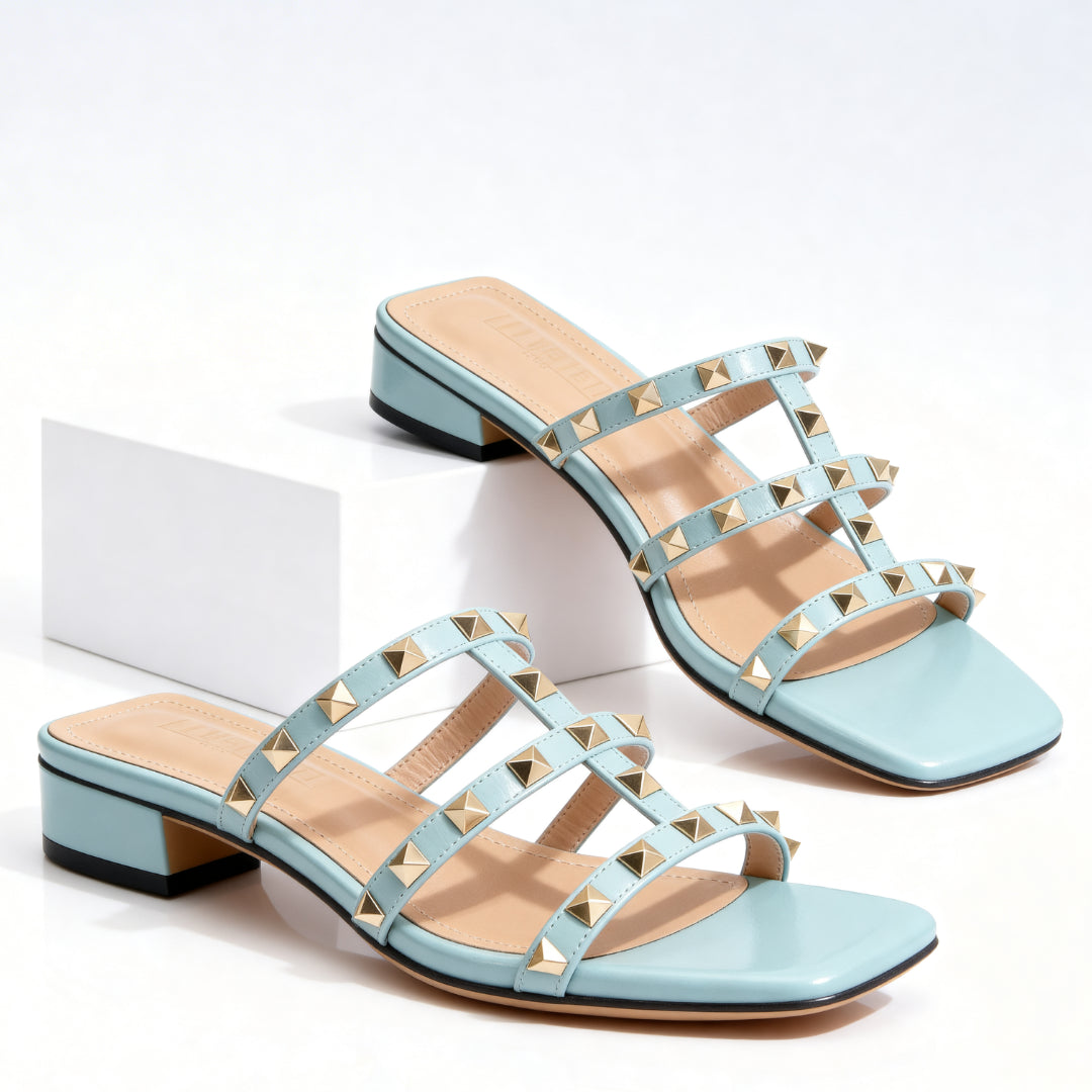 Woman walking in studded block heel mules, street style shot