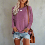 Model wearing relaxed fit top, casual seated pose