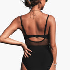 Black one-piece swimsuit with low back design, rear view