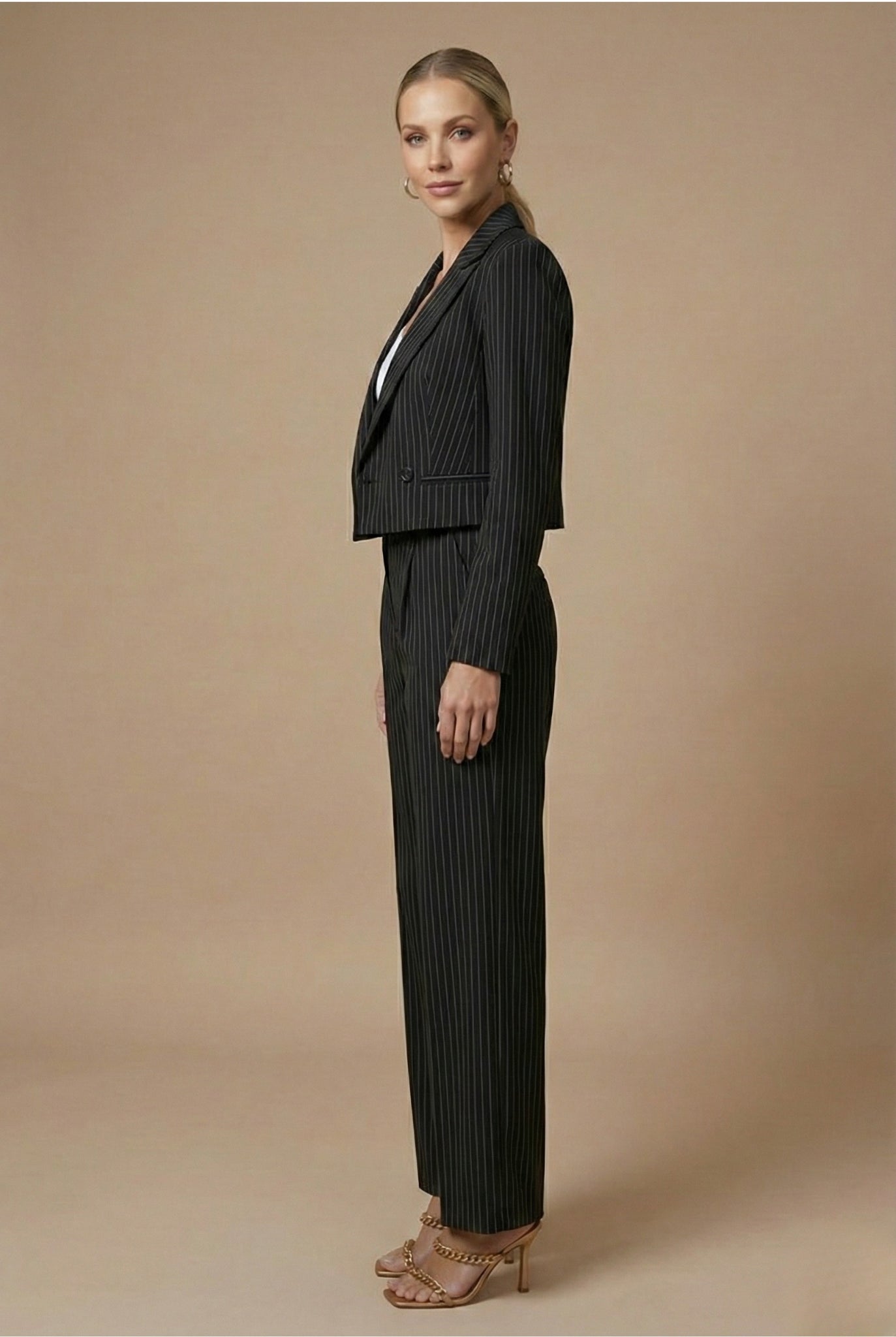 Model wearing pinstripe blazer and wide leg trousers, front view