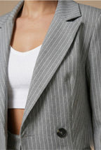 Model in pinstripe suit showing side profile and trouser fit