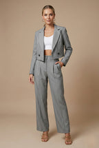 Close-up of cropped blazer notched lapel and button front detail