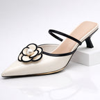 Woman wearing black pearl flower mule, standing pose showing full silhouette