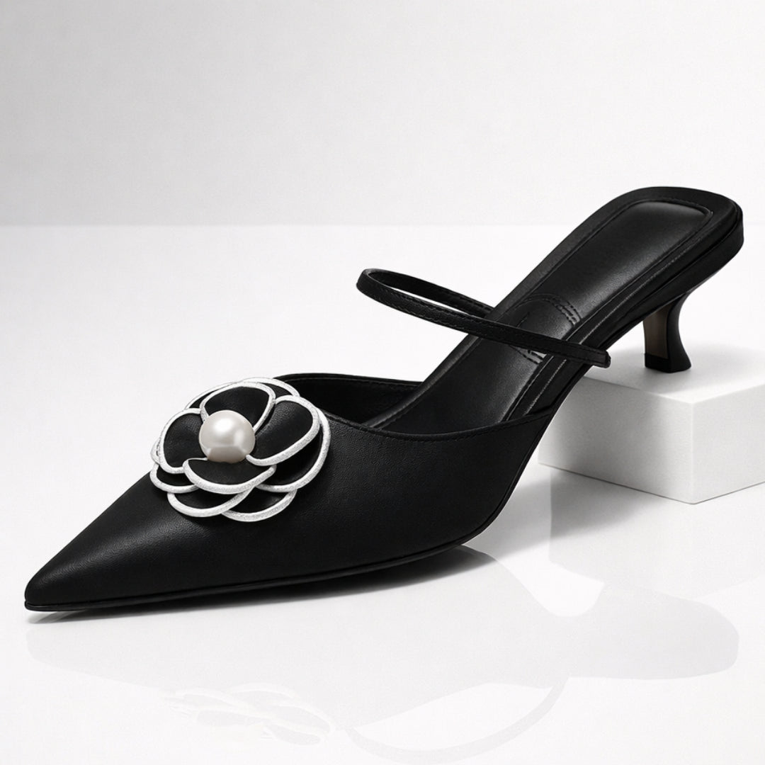 Black leather pointed toe kitten heel mule with white pearl flower embellishment, front view