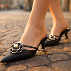 Side profile of pointed toe kitten heel mule displaying low heel height