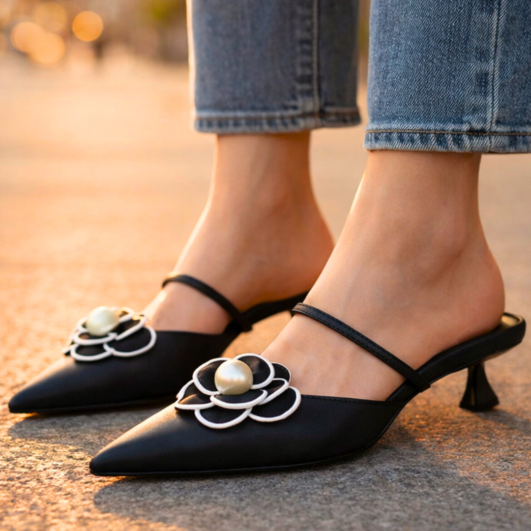 Detail shot of cushioned insole and interior of black leather mule