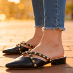 Side profile of mule emphasizing low heel and stability sole