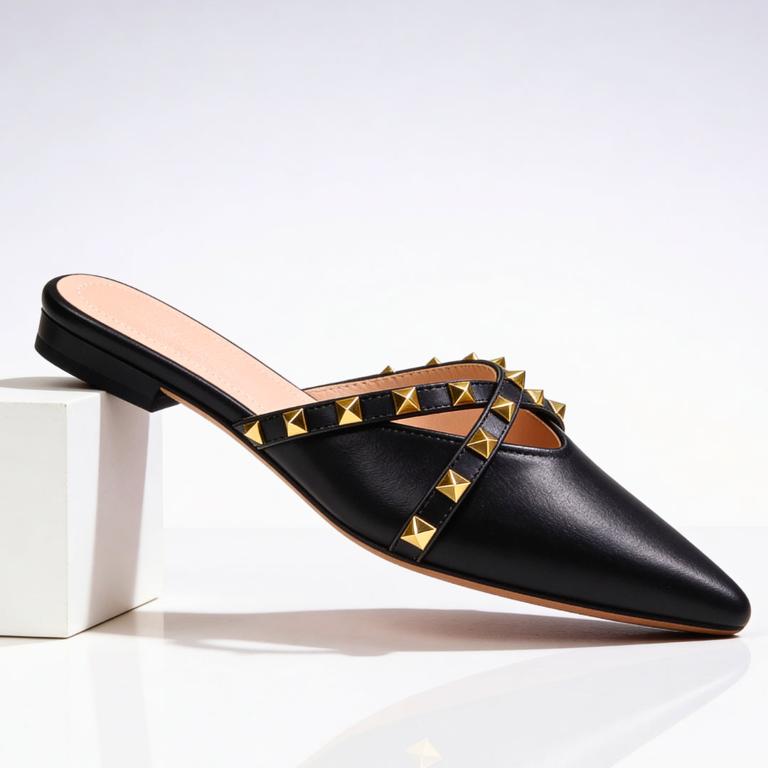 Side view of studded mule showing pointed toe silhouette and low-profile sole
