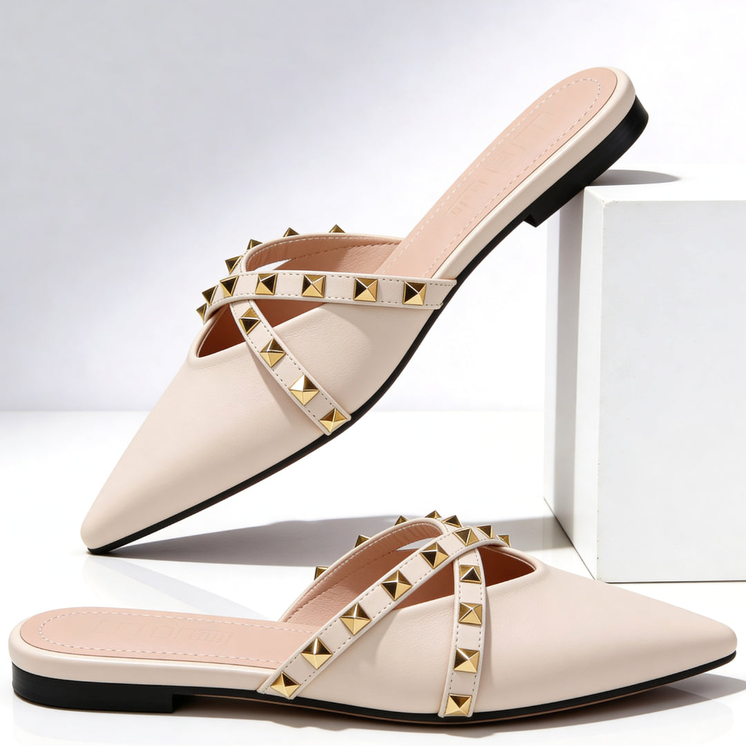 Woman wearing studded mules while standing, showcasing full shoe design