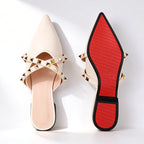 Woman walking in studded mules on flat surface