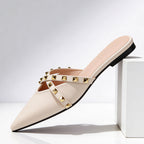 Close-up of gold pyramid studs on mule crossover strap