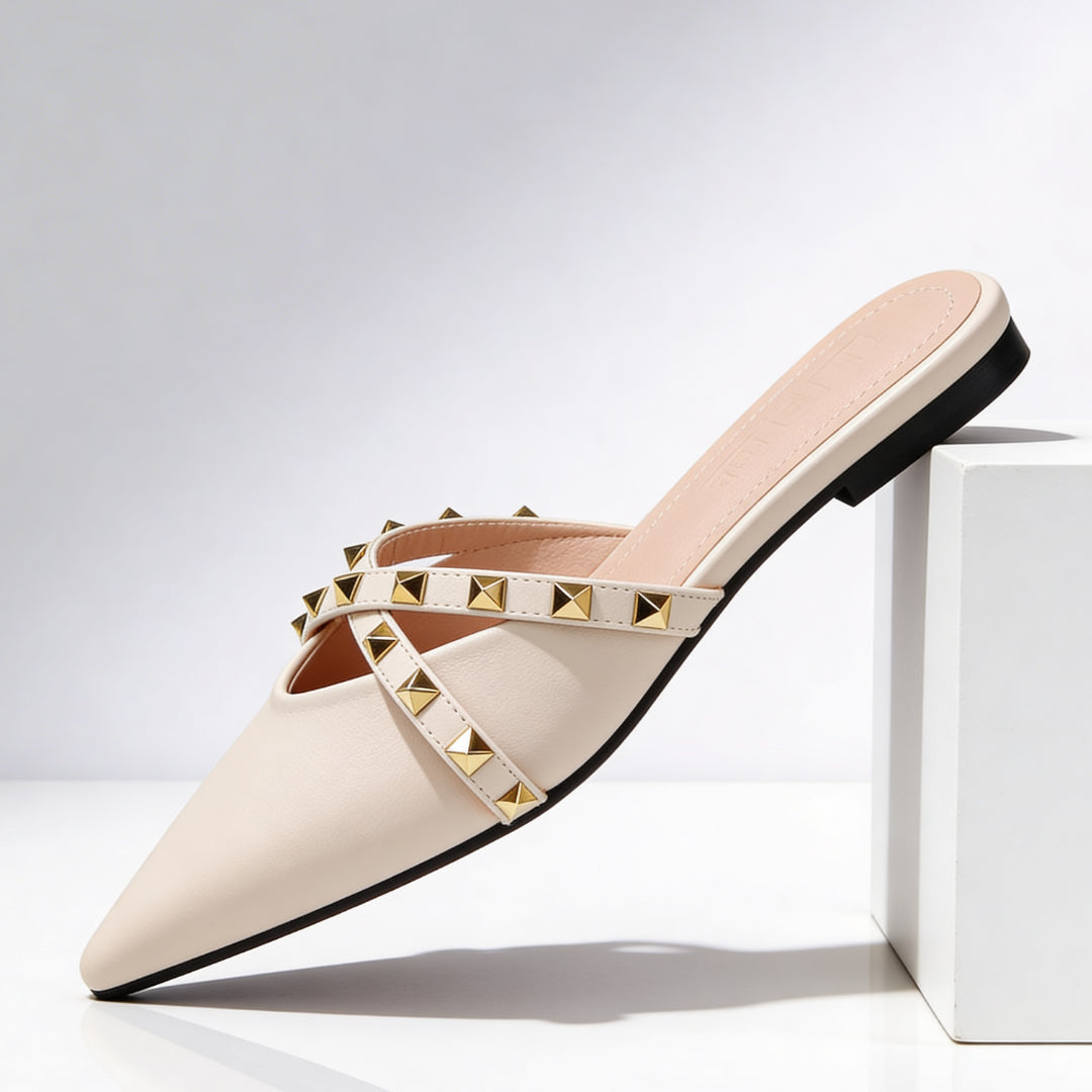 Close-up of gold pyramid studs on mule crossover strap