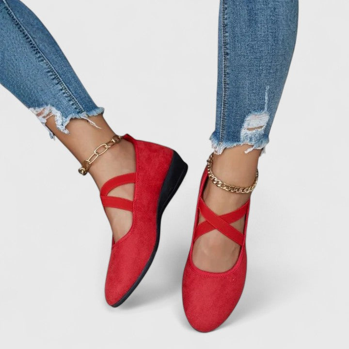 Black suede ballet flats shown from above at three-quarter angle