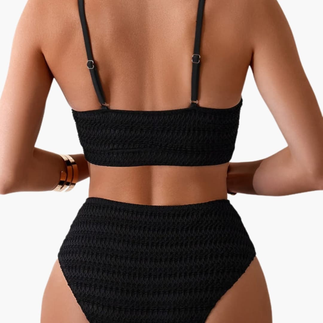 Model wearing textured bikini set, front-facing pose showcasing high-waisted fit