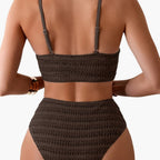 Model in bikini set shown from side angle highlighting structured silhouette