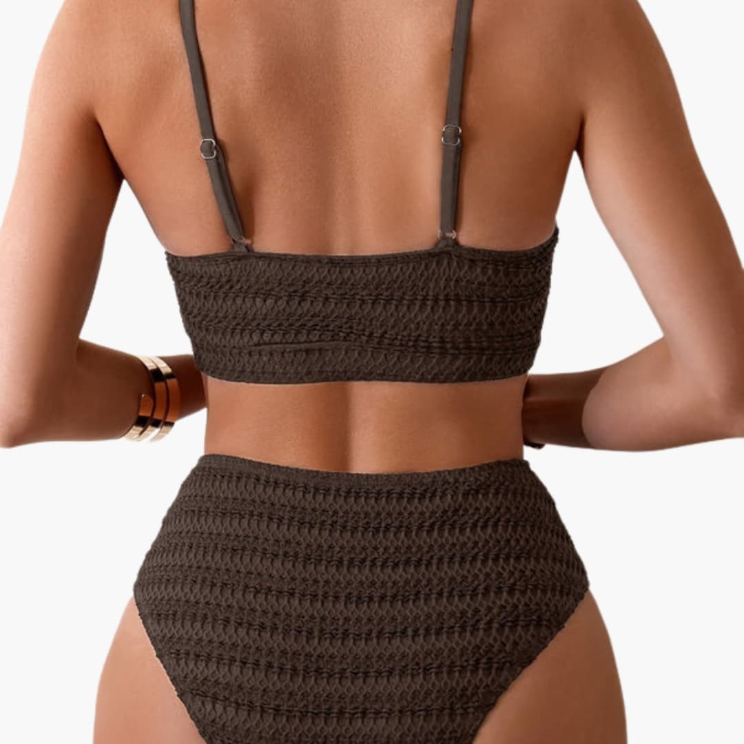 Model in bikini set shown from side angle highlighting structured silhouette