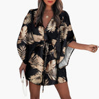 Women's tropical leaf print mini dress with button front and V-neckline, full length view