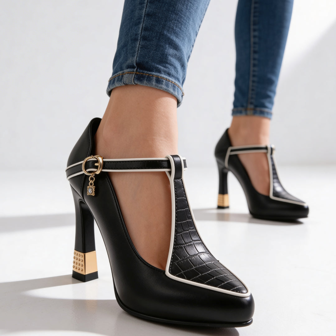 Close-up of T-strap design and ankle buckle with charm detail