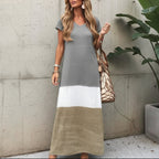 Model wearing colourblock maxi dress standing against plain background
