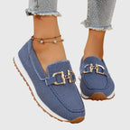 Women's denim slip-on loafers with gold horsebit hardware, front view
