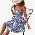 Side profile of model in blue floral dress showing flared skirt silhouette