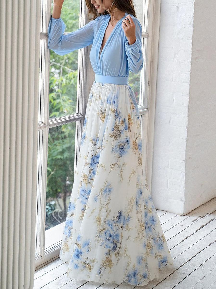 Model wearing blue floral maxi dress, side pose showing flowing skirt and waist detail