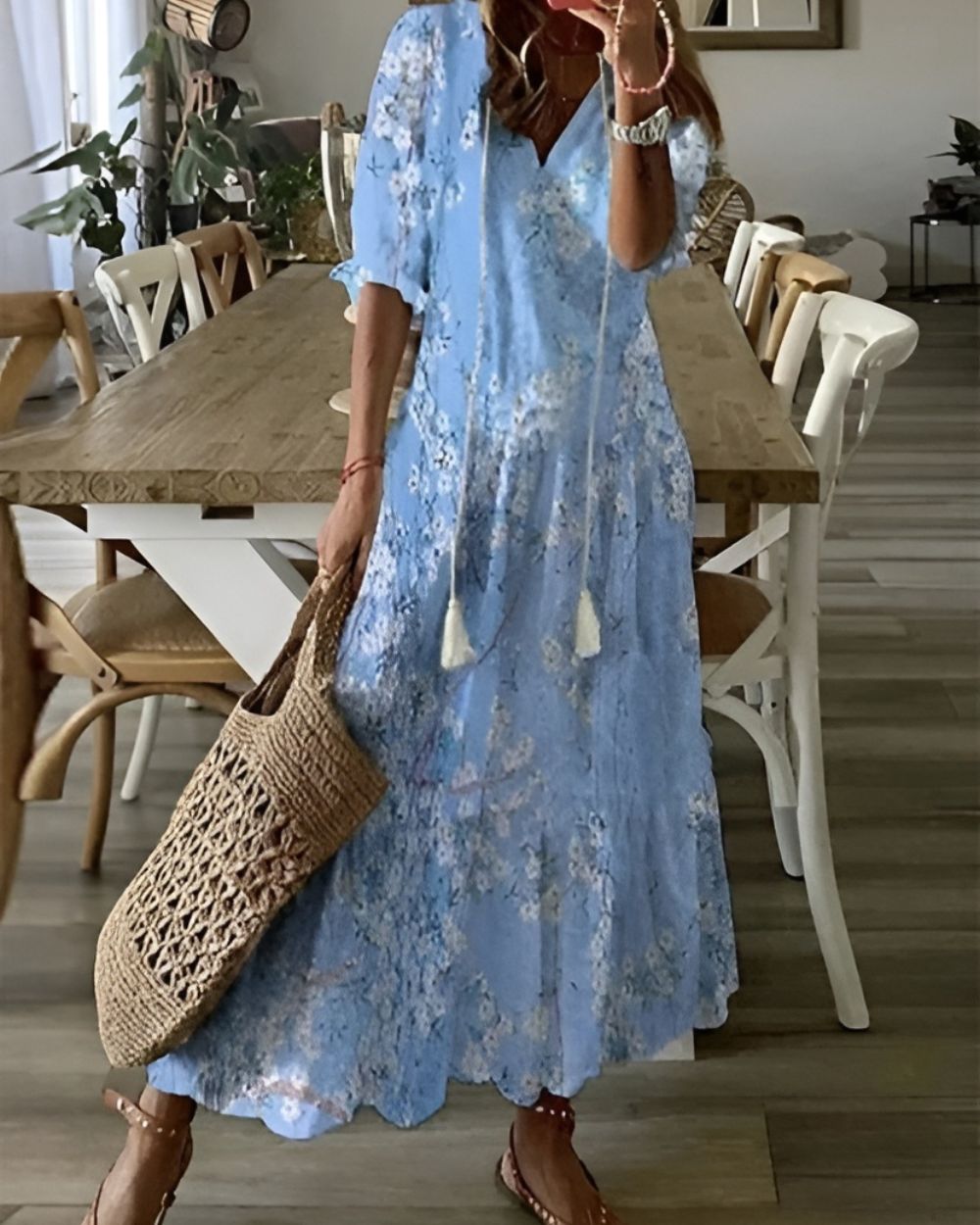 Woman in ikat maxi dress walking, rear three-quarter view