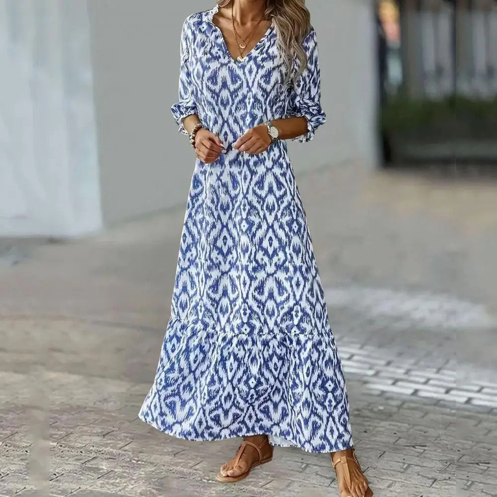 Woman wearing blue ikat maxi dress with V-neckline, full-length front view