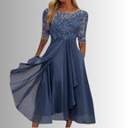 Woman wearing lace chiffon midi dress with sheer sleeves, front view