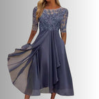 Full-length shot of model in dress showing movement of chiffon fabric