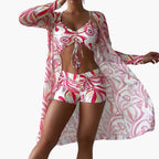 Model in complete three-piece set with sheer robe worn over bikini