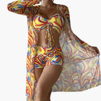 Close-up of bold blue, red and cream swirl print on bikini fabric