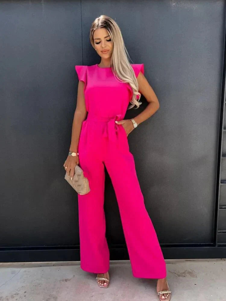 Side angle of jumpsuit highlighting tie waist and flowing wide legs